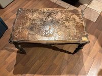 Top view showing peeling veneer and worn finish