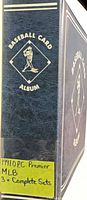 Spine of dark blue Baseball Card Album with handwritten note "1991 O.P.C Premier MLB 3× Complete Sets"