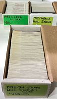 Three cardboard boxes labelled 1993 Fleer Ultra NHL, 1993 Pinnacle NHL Singles, 1993-94 Topps NHL Stadium Club Singles