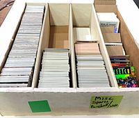 Four-row cardboard box filled with loose sports cards