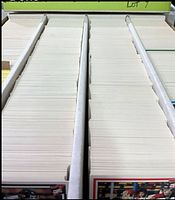 Three-row storage box filled with large quantity of trading cards