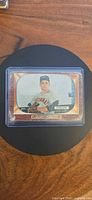 Front view of 1955 Bowman #189 Jack Collum card in protective holder
