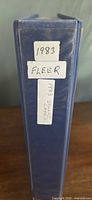 Spine of blue binder showing handwritten labels "1983 Fleer"