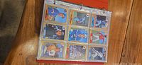Binder open showing nine O-Pee-Chee 1987 baseball cards per sleeve