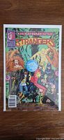 Front cover of The Strangers #2 comic in bag and board