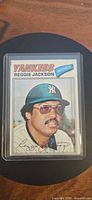 Front view of Reggie Jackson 1977 Topps card in top loader