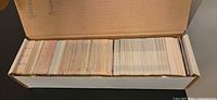 Full view of open cardboard box showing large quantity of hockey cards neatly packed