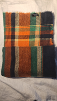 Scarf folded showing plaid pattern and fringe