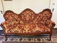 Full front view of Victorian sofa showing wood frame, upholstery, cabriole legs