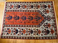 Full view of rug showing field, border, and design