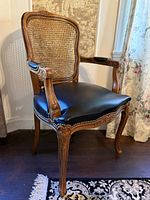 Full view of fauteuil showing cane back, leather seat, cabriole legs