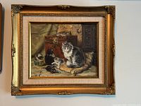 Front view of framed painting showing cat and kittens scene