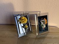 Two mirrored frames with porcelain flower arrangements