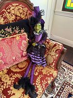 Witch shelf sitter seated on chair showing full outfit and dangling legs