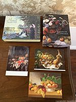 Monet The Early Years box, French Flowers box, three loose notecards on tabletop
