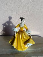 Front view of Royal Doulton Stephanie figurine in yellow gown