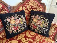 Both needlepoint pillows on settee showing overall appearance