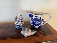 All three ceramic items on wooden surface