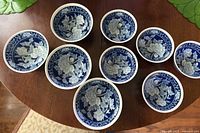 All nine blue and white porcelain bowls displayed on table