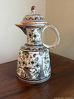 Front view showing rabbit motif, spout, handle, lid