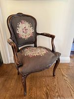 Full view of carved Louis XV style armchair with needlepoint upholstery