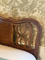 Close view of carved wooden headboard detail