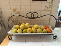 overall view of metal stand with glass tray full of fruit