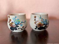 Front view of both teacups showing hand-painted blossom design