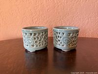 Two celadon porcelain burners side by side showing size and glaze