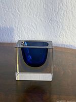 Front view of clear glass cube with blue interior