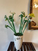 Full view of glass flower bouquet in ceramic vase