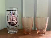 Front view of Pepsi advertising glass and two pink textured tumblers
