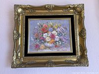 Full view of framed painting hung on wall