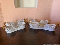 Group view of six porcelain swan flatware holders showing overall condition and design