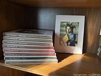 Stack of nine Time Life Library of Art books on shelf, spines visible