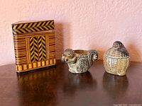 Front view of wood box, ceramic squirrel vessel, lidded bird dish