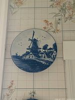 Front view of round blue-and-white plate showing windmill scene