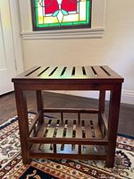 Full view of wood slatted end table showing top and shelf