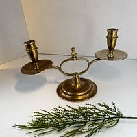 Overall view of brass two-arm candelabra side angle