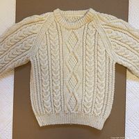 Sweater laid flat front view showing overall design and condition