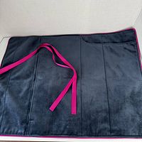 Open view of navy interior pouch with fuchsia ribbon and trim