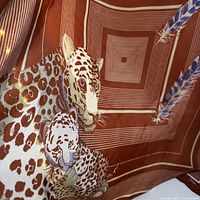 Full scarf showing leopard graphic, feathers, concentric stripe border