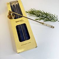 Box with four navy Molca tapers and brass snuffer displayed