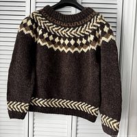Front view of brown wool Icelandic sweater on hanger