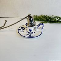 Delft chamberstick and metal snuffer side view