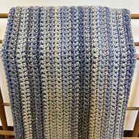 Afghan draped to show stripe pattern and stitch detail