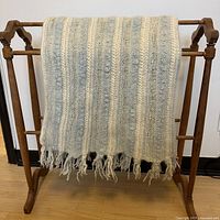 Entire blanket draped on rack showing size and stripe pattern