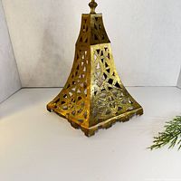 Front view of pierced brass wall lamp shade