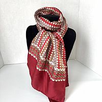 Scarf draped on mannequin displaying pattern and border