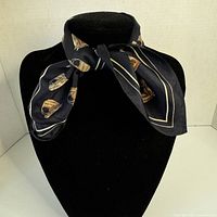 Scarf tied on mannequin neck showing colour and motif